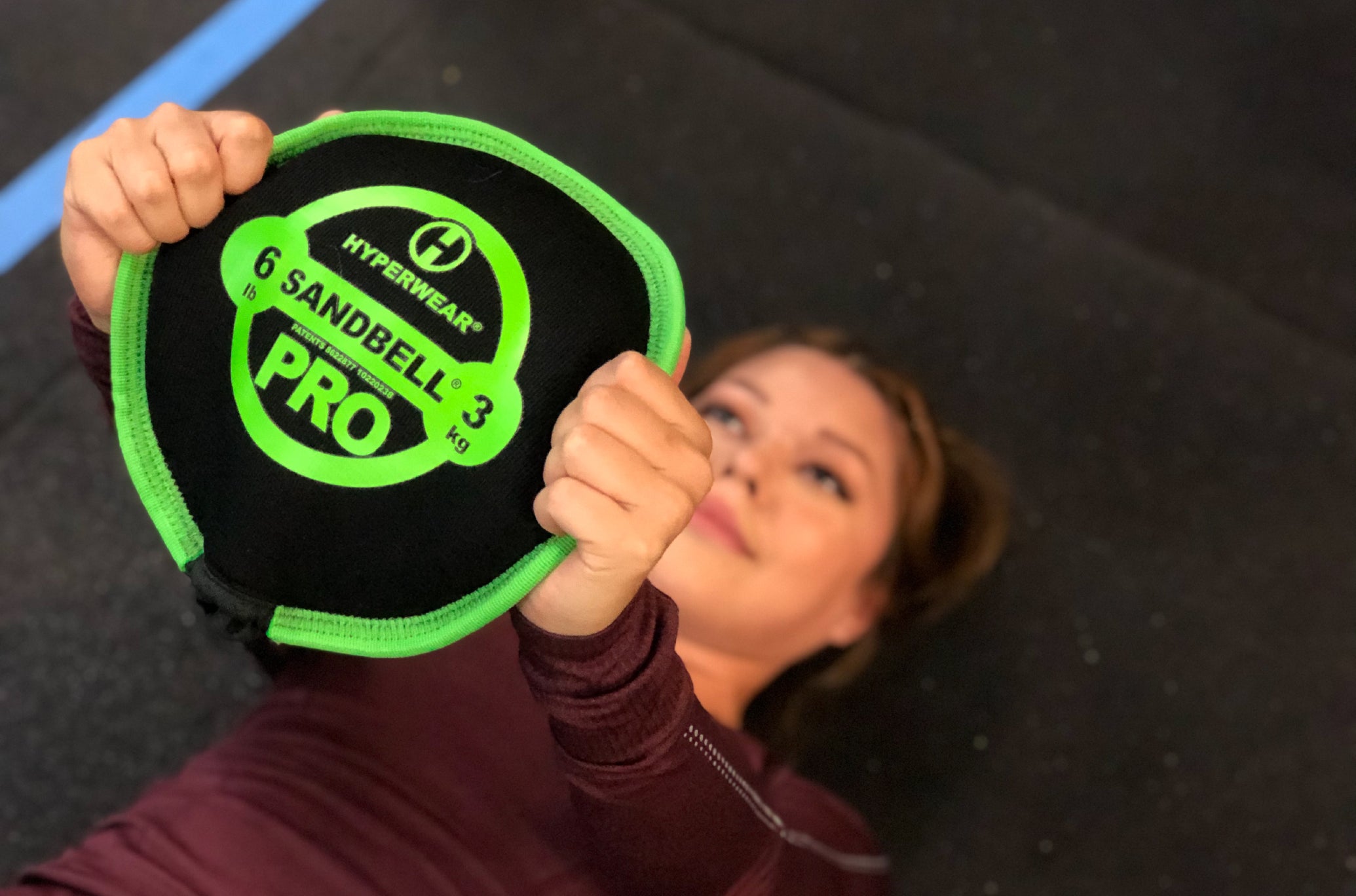 Woman Working Out With Green Hyperwear Sandbell Pro